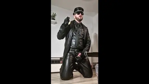 Leather Clad Men Engage in Intense Fetish Play