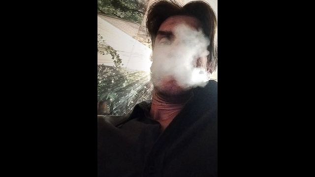 Leather Boy Shares Cigar Smoke in Fetish Scene