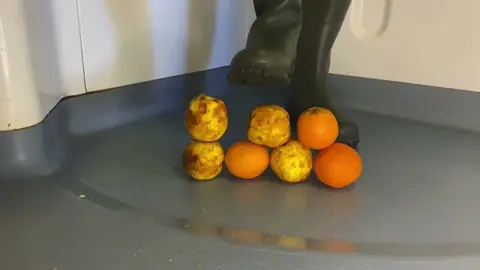 Fetish Guy Crushes Fruit in Rubber Boots