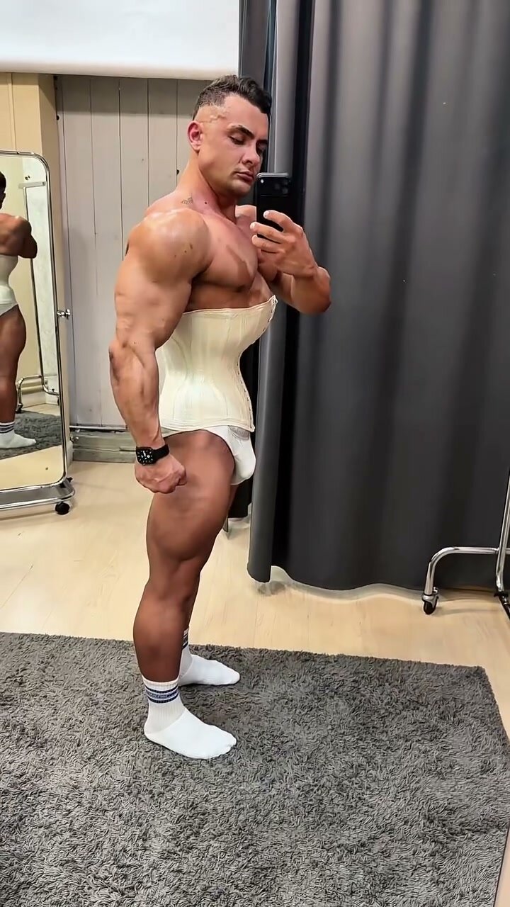 Bodybuilder Wears Corset for Fetish Play