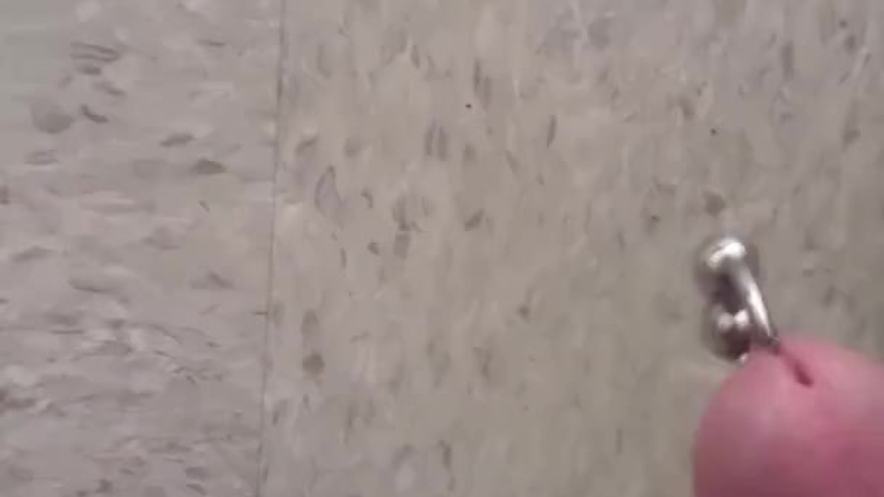 Guy Pisses on Public Tile in Outdoor Scene