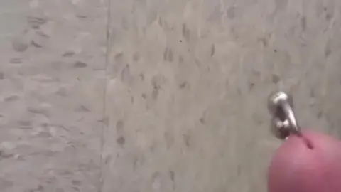 Guy Pisses on Public Tile in Outdoor Scene