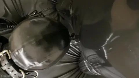 Rubber Gimp Gives Oral to Rubber Cock