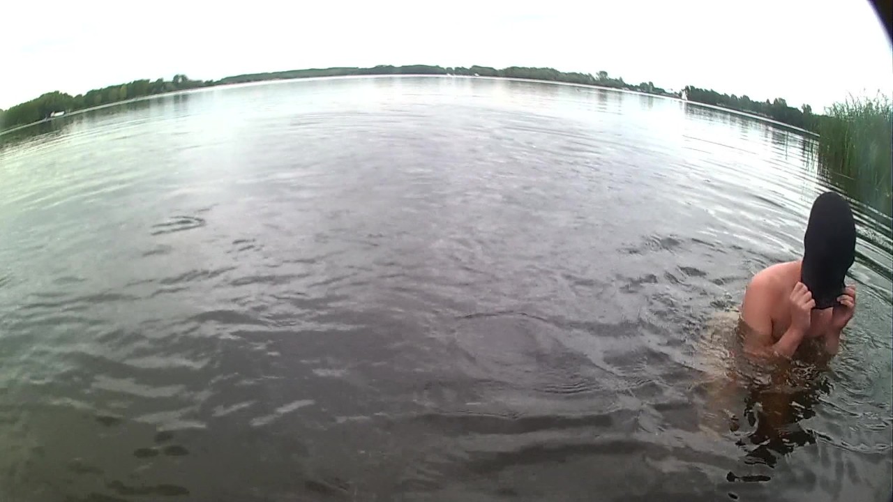 Nude Guy Takes Risky Swim in Lake with Soft Erection