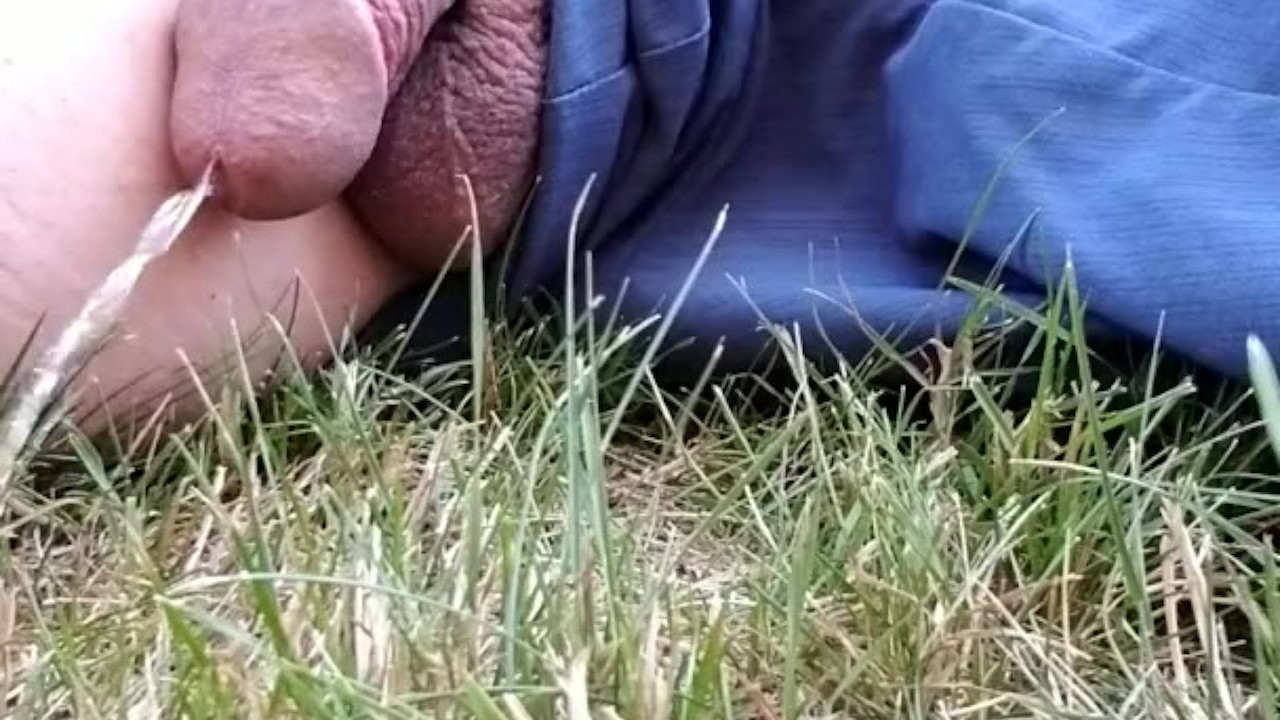 Guy Urinates Outdoors in Public Park