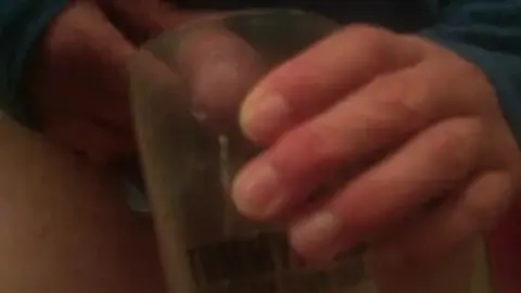 Gay Guy Urinates in Cup in Slow Motion