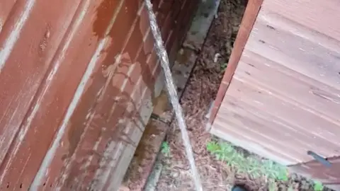 Guy Pisses Behind Shed in Work Trousers