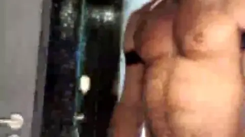 Muscle Man Shows Off in Shower with Fetish Gear