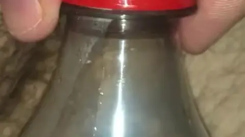 Guy Pisses in Bottle on Request