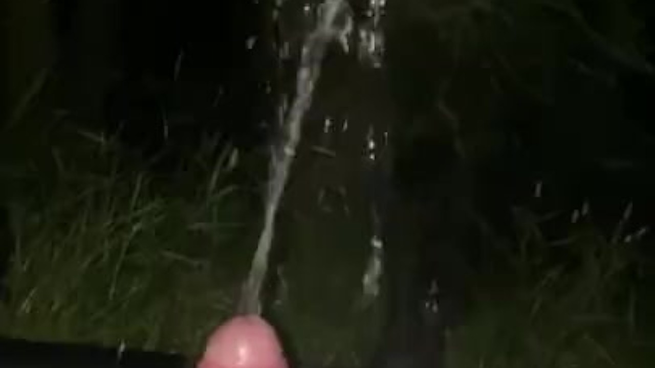 Guy Pisses on Himself Outdoors in Field