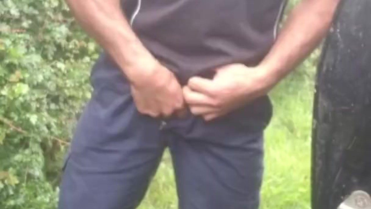 Man in Uniform Pisses in Rubber Boots