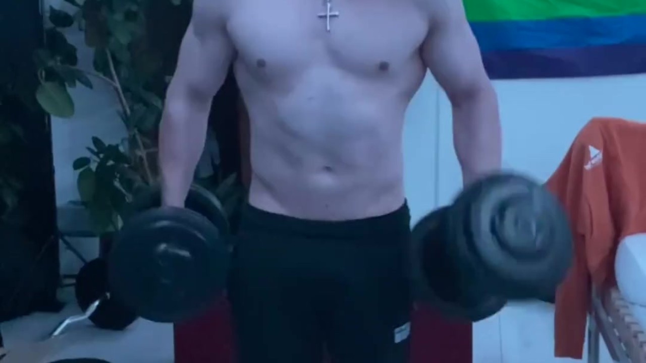 Shirtless Guy Lifts Heavy Curls at Home