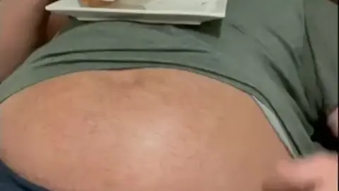 Hunky Men Feast on Large Sandwiches