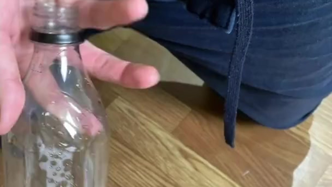 Young Guy Pisses into Bottle