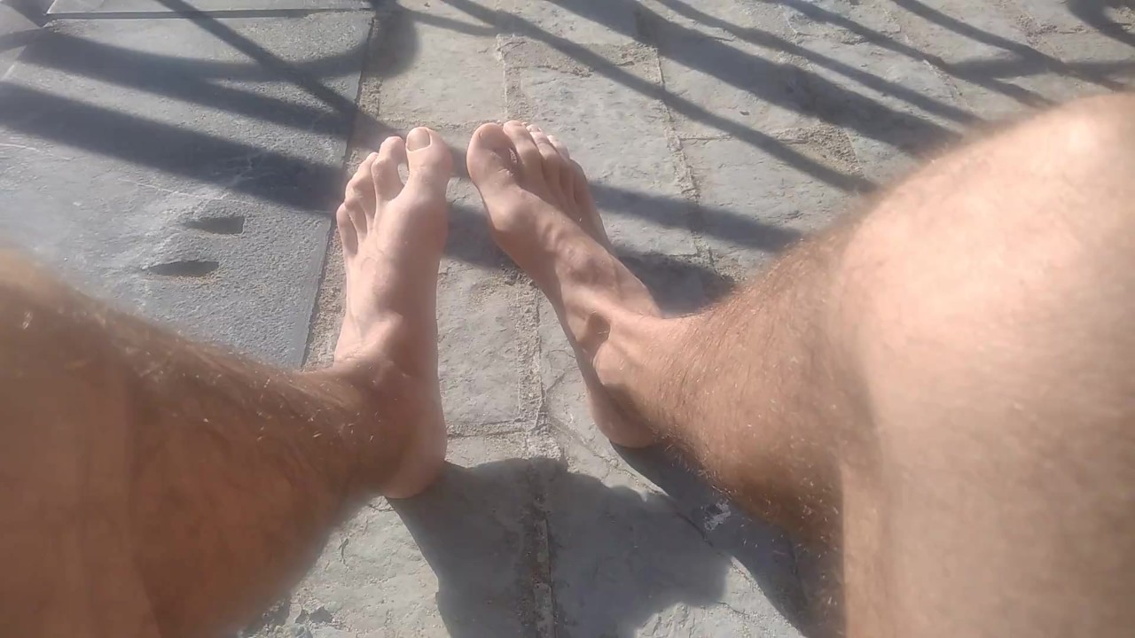 Hairy Guy Marks Cock on Beach with Feet