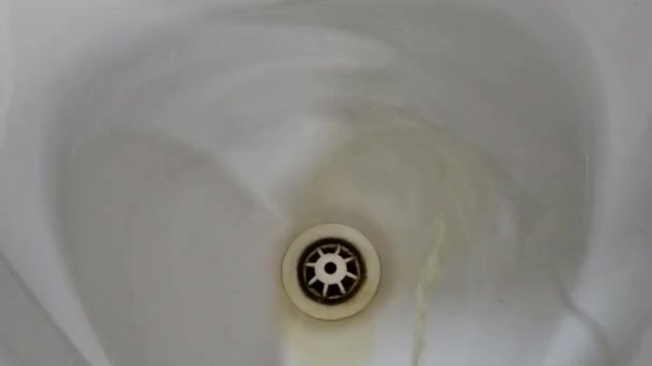 Men Pissing in Public Restroom Urinals