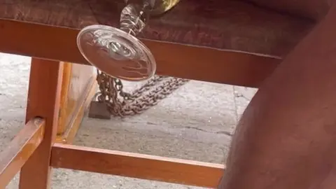 Man Drinks Piss from Glass in Public Street Restaurant